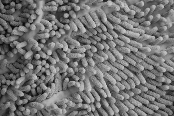 Processed image of fluffy gray doormat from bathroom in grey color