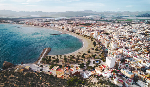 Aerial view to Aguilas coastline, townscape, sandy beach and Mediterranean Sea waters view from above. province of Murcia. Spain