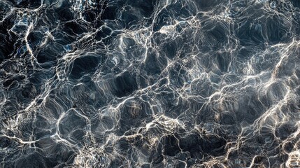 Obraz premium Close-up of shimmering water surface texture with ripples and reflections in natural light creating a tranquil and soothing visual effect