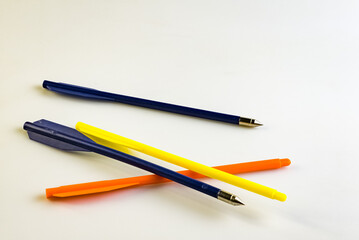 Arrows for a training crossbow on a white background. Arrows with and without tips. Blue, yellow and orange.