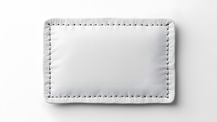 Fototapeta premium Minimalist High-Contrast White Fabric Patch Mockup, Blank Rectangular Textile with Stitched Border for Branding and Graphic Design