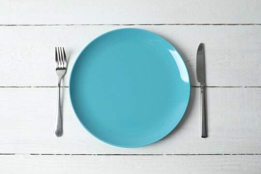 Minimal table setting on wooden background, top view