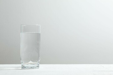 Transparent glass with water on a wooden table. Drinking clear water in the morning for health