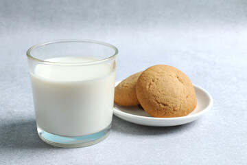 Glass of milk with cokies on the table