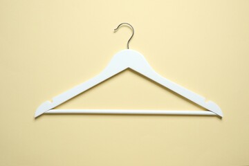 Wooden clothes hanger on a colored background