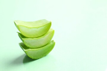 Cut aloe vera on color background