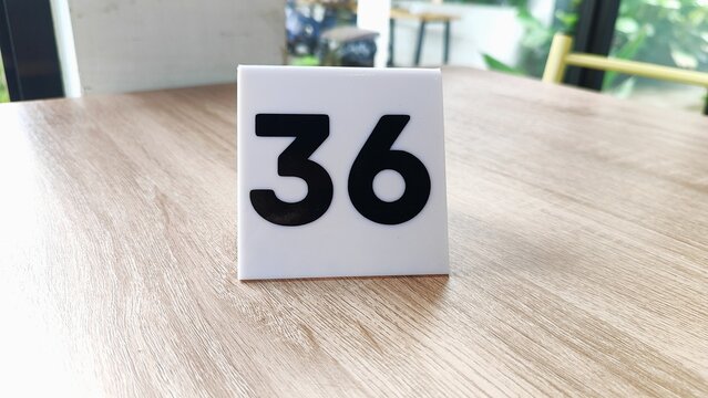 the black and white restaurant waiting table number is number thirty-six