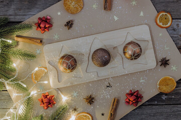 Three creative chocolate dessert Christmas balls on the table.