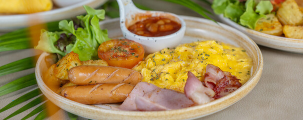 Breakfast with fried eggs and bacon and sausage. Breakfast set at hotel. Hearty Traditional Breakfast Plate with Eggs, Sausage, Bacon, Toast, and Vegetable Salad.