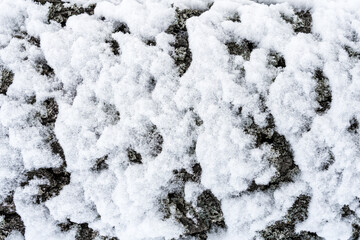 Close-up of snow-covered surface creating a textured winter landscape.