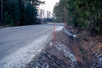 road construction, fresh ditches, slippery road, gravel road, forest path, Latvia landscape, red marks, sandy ditch, water drainage
