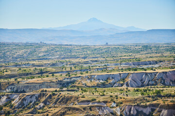 Mountains around the city of Uchhisar from a height in Cappadocia, Central Anatolia region, Turkey. Tuff mountains.