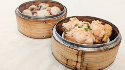 Photo of Steamed delicacies served in bamboo baskets, showcasing traditional Chinese dim sum...