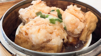 Photo of Steamed delicacies served in bamboo baskets, showcasing traditional Chinese dim sum cuisine. Concept of Chinese new year, lunar year, dim sum, dumpling, authenticity, celebration