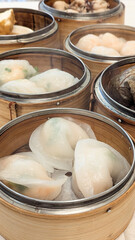 Photo of Steamed delicacies served in bamboo baskets, showcasing traditional Chinese dim sum cuisine. Concept of Chinese new year, lunar year, dim sum, dumpling, authenticity, celebration