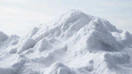 A large pile of snow sits atop a snow-covered ground, ideal for winter scenes or outdoor activities