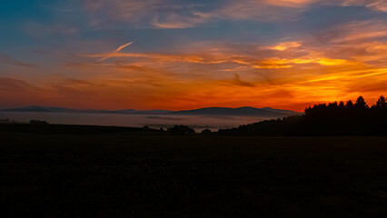 Foggy sunrise with dramatic clouds near Kirchberg im Wald, Regen, Bavarian Forest, Bavaria, Germany