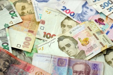 Big amount of different ukrainian hryvnia currency money bills in pile