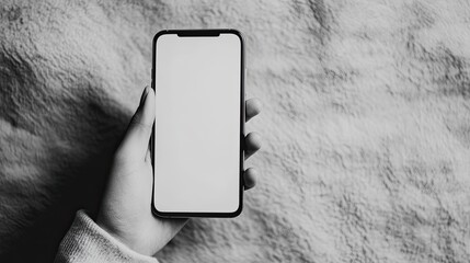 Black and White Hand Holding Cell Phone on Textured Paper Background
