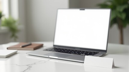 Fototapeta premium A sleek laptop and digital tablet sit on a minimalist white desk with a potted plant, creating a modern and clean workspace