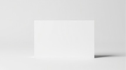 Naklejka premium Blank white tent card standing on a minimalist surface, perfect for branding, presentations, or custom design uses