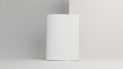 Minimalistic white book standing upright against a light pink background, showcasing simplicity and elegance