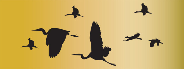 Black silhouettes of flock of flying swans. Vector on yellow background