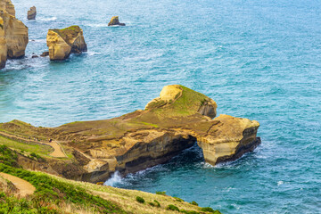 Beautiful Tunnel Beach located southwest of Dunedin city. Tunnel Beach is sea-carved sandstone cliffs with rock arches and caves