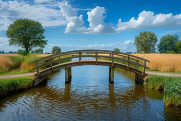 Fototapeta premium A serene wooden bridge over a calm river surrounded by lush greenery and vibrant skies, perfect for nature lovers.