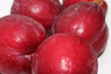 group of red fruits. set of plums. plums with selective focus.