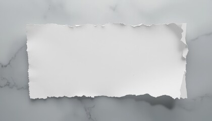 Obraz premium A blank torn white paper with irregular edges on a marble surface