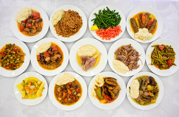 Delicious meat kebab with fresh vegetable salad served with variety of Turkish dishes and appetizers. Top view of assorted Turkish food and meze, tasty and healthy Mediterranean cuisine.