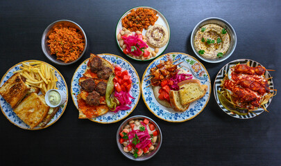 Delicious meat kebab with fresh vegetable salad served with variety of Turkish dishes and appetizers. Top view of assorted Turkish food and meze, tasty and healthy Mediterranean cuisine.