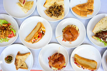 Delicious meat kebab with fresh vegetable salad served with variety of Turkish dishes and appetizers. Top view of assorted Turkish food and meze, tasty and healthy Mediterranean cuisine.