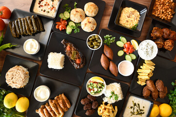 Delicious meat kebab with fresh vegetable salad served with variety of Turkish dishes and appetizers. Top view of assorted Turkish food and meze, tasty and healthy Mediterranean cuisine.