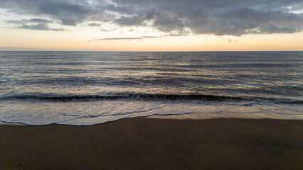 Drone aerial view of a sunset on a beach near Peniscola in Spain.