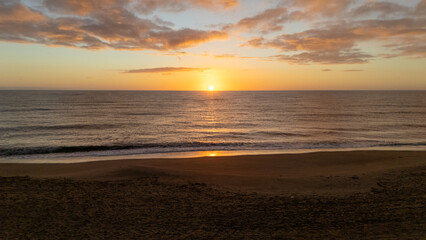 Drone aerial view of a sunset on a beach near Peniscola in Spain.