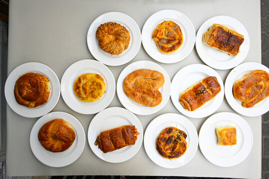 Turkish style meat stuffed filo dough borek served kol boregi.Cheese and minced pie are sliced on a marble background. Turkish name: Kol Boregi, kiymali, peynirli su boregi. Ci borek. Kafkas cig borek