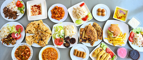 Delicious meat kebab with fresh vegetable salad served with variety of Turkish dishes and appetizers. Top view of assorted Turkish food and meze, tasty and healthy Mediterranean cuisine.