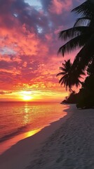 Fototapeta premium Stunning sunset over a tranquil beach with palm trees silhouetted against the colorful sky. Experience the beauty of nature in this peaceful coastal scene.