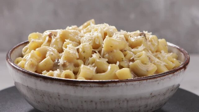 mac and cheese in bowl on light surface rotation food 