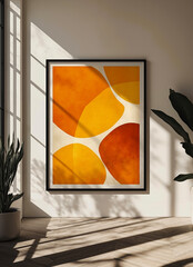 A picture hanging on a wall next to a potted plant in a room