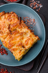 Lasagna or pasta layered with meat, cheese, salt, spices and herbs