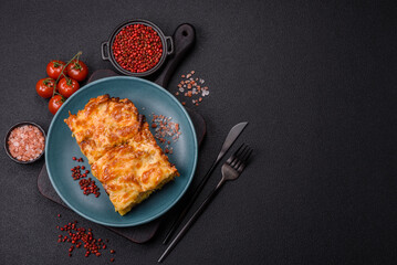 Lasagna or pasta layered with meat, cheese, salt, spices and herbs