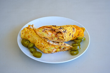 Lavash doner kebab ( soslu kasarli zurna doner durum )  or shawarma sliced in plate isolated.  Tavuk Et Doner Durum. Hatay Iskenderun usulu bazuka, zurna  tavuk doner durum. 