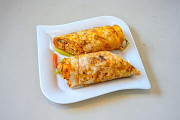 Lavash doner kebab ( soslu kasarli zurna doner durum )  or shawarma sliced in plate isolated.  Tavuk Et Doner Durum. Hatay Iskenderun usulu bazuka, zurna  tavuk doner durum. 