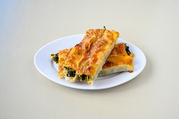 Turkish style meat stuffed filo dough borek served kol boregi.Cheese and minced pie are sliced on a...