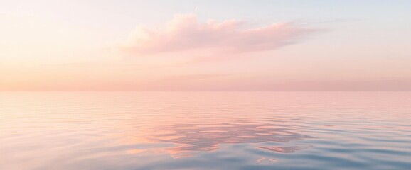 Fototapeta premium Peaceful pink sunset reflecting on calm ocean water.