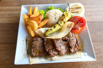 Famous Urfa meat liver, ciger wrapped by lavash with roasted chili pepper, onion and sauce in Sanliurfa, Turkey. Kuzu et ciger sis. Izgara dana bonfile, cop sis, kuzu pirzola. Karisik kebap, beyti keb