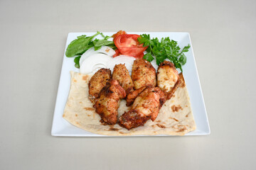 Chicken wings barbeque in a dish with BBQ grill sauce . Izgara tavuk kelebek sis kanat. Tavuk sis, gogus.